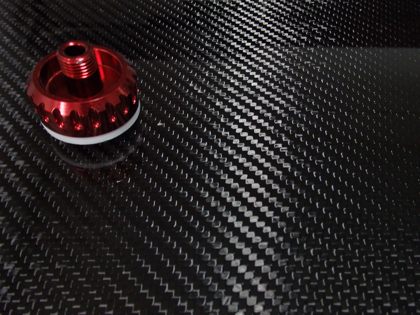 Why is carbon fiber still used to manufacture Formula One racing cars