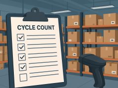 Warehouse worker performing cycle count inventory check among organized shelves and storage boxes