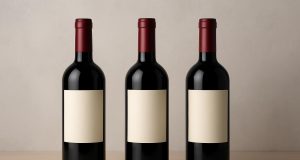 Branded wine bottles with consistent packaging design on a shelf for brand recognition