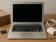 Used MacBook with scratched surface and worn keyboard on a desk, highlighting device condition.