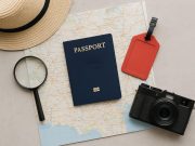 Open passport with travel stamps and world map, representing solutions for lost passports abroad
