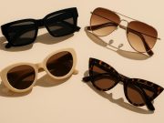 Assorted trendy sunglasses displayed on a stylish white surface showcasing latest fashion styles