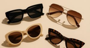 Assorted trendy sunglasses displayed on a stylish white surface showcasing latest fashion styles