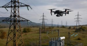 Drone inspecting power lines to monitor and maintain aging energy infrastructure for reliability