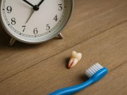 Dislodged tooth on a surface with dental tools emphasizing urgent emergency dental care