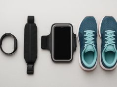 Running shoes, fitness tracker, water bottle, and armband displayed for beginner runners