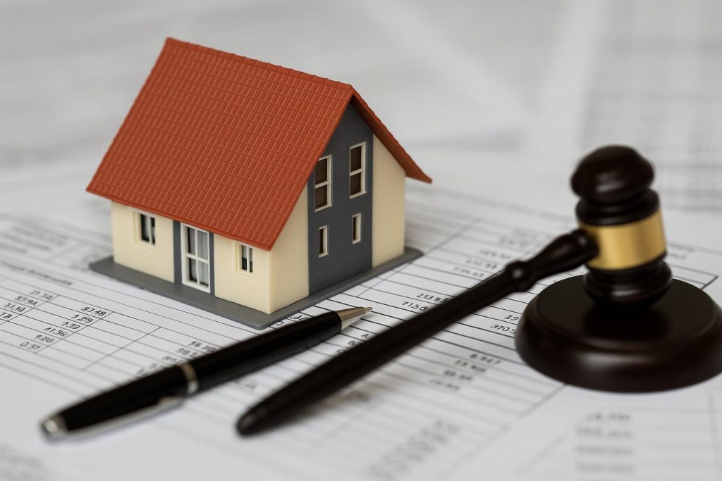 House with calculator and tax documents representing property tax assessment appeal process