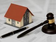 House with calculator and tax documents representing property tax assessment appeal process