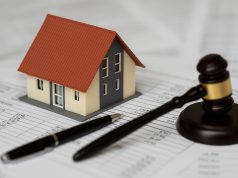 House with calculator and tax documents representing property tax assessment appeal process
