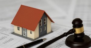 House with calculator and tax documents representing property tax assessment appeal process