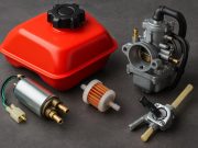 Close-up of a motorcycle carburetor and fuel lines illustrating powersports fuel systems