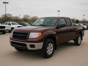 Pre-owned pickup truck parked on dealership lot highlighting benefits over new models