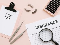 Accredited lash academy classroom with certification materials and industry insurance documents
