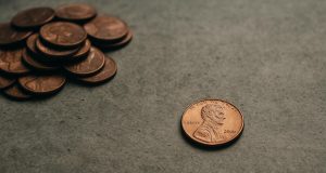 Pile of U.S. pennies emphasizing their decreasing value and relevance in modern currency