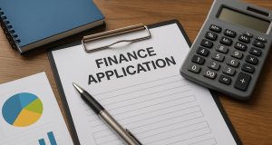 Financial documents and calculator on desk representing successful finance application preparation