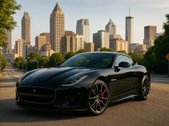 Sleek luxury car parked in downtown Atlanta near iconic city landmarks